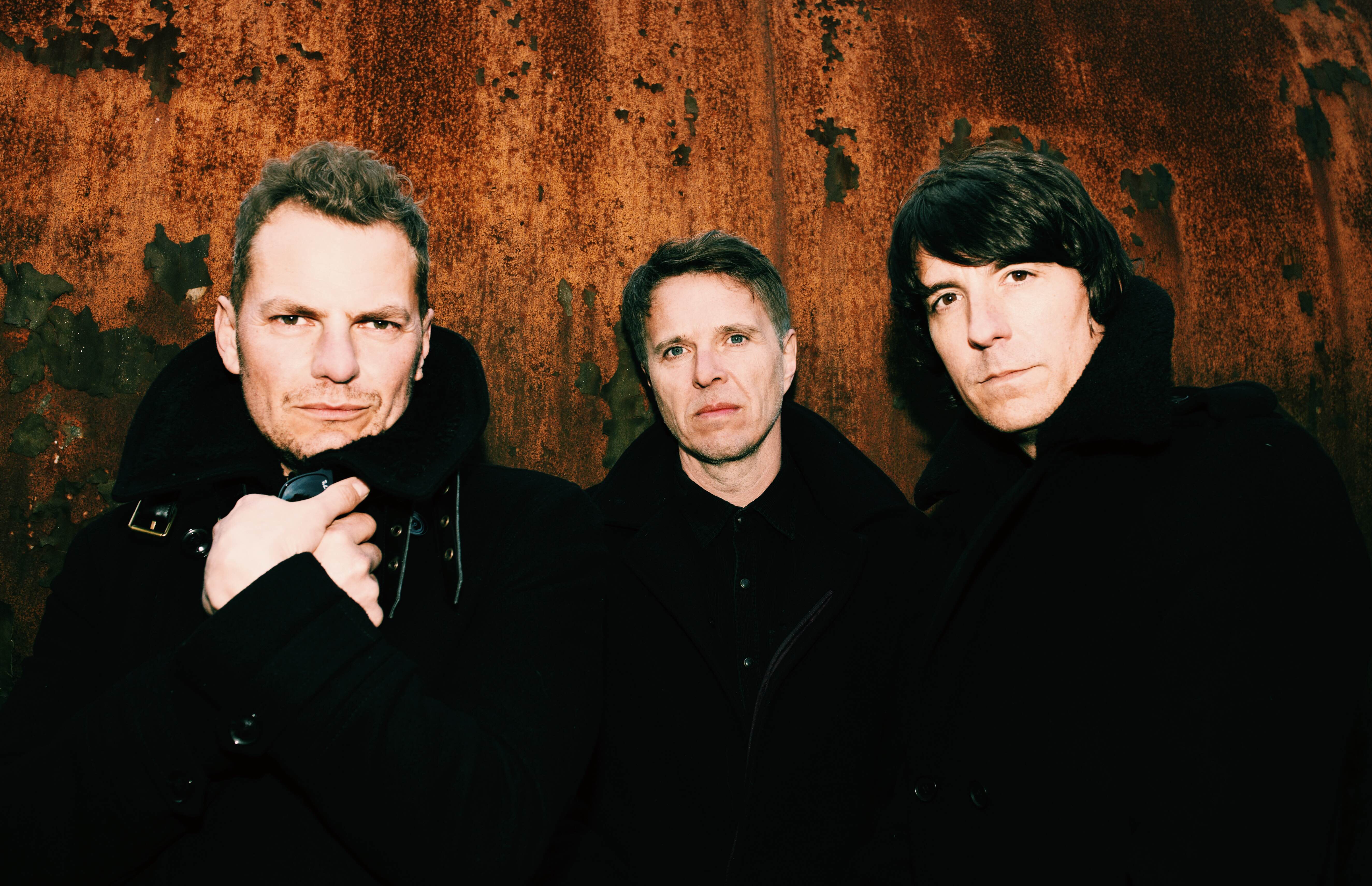 photo of the three men from Toploader, dressed in black