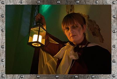 Image of woman holding spooky candle for Candle Ghost Tours at Tamworth Castle